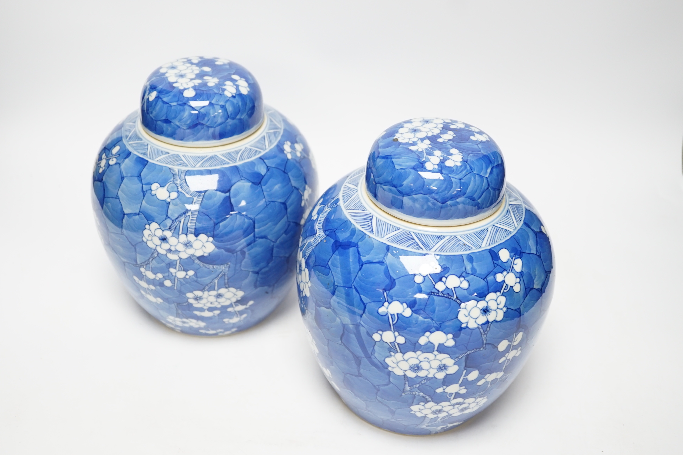 A pair of Chinese blue and white prunus jars and covers, late 19th century, 21.5cm